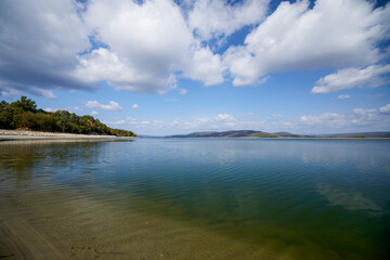 beautiful landscape with clouds reflecting on a lake during the day