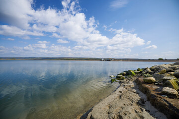 beautiful landscape with clouds reflecting on a lake during the day