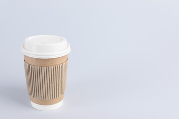 Paper cup with plastic lid on light background, space for text. Coffee to go