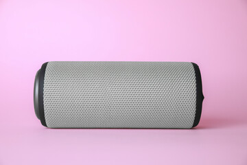 One portable bluetooth speaker on pink background. Audio equipment