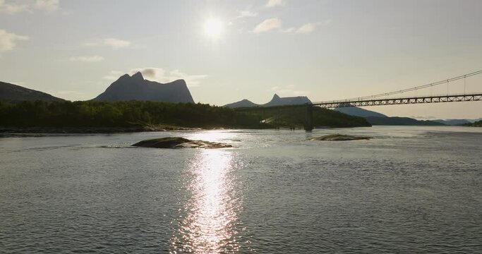 Glistening Water At Kjerringstraumen Bru (Efjord Bridges) On The Efjorden During Sunrise In Nordland County, Norway. Aerial Wide Shot