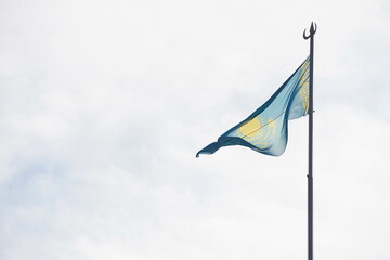 Almaty, Kazakhstan - 10.02.2023 : The national flag of the Republic of Kazakhstan on the City Hall building.
