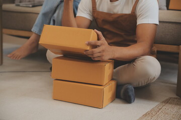 Startup small business owner working with computer at workplace. Freelance two woman seller check product order. Packing goods for delivery to customer. Online selling. E-commerce. Online Shopping