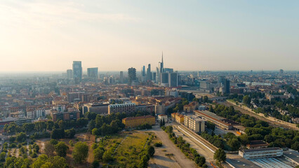 Milan, Italy - July 15, 2023: The famous skyscrapers of Milan are located around the botanical garden Campo di Fiori BAM. Milano Porta Garibaldi train station, Aerial View - obrazy, fototapety, plakaty