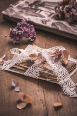 Memories, antique and old family photos with  dried flowers in vintage style on wooden table