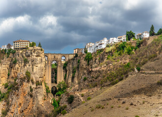 New bridge (Puente Nuevo) and the famous white houses on the cliffs in the city Ronda, Andalusia, Spain.
