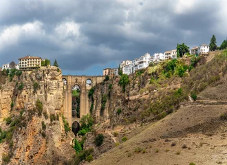Fotobehang Ronda Puente Nuevo New bridge (Puente Nuevo) and the famous white houses on the cliffs in the city Ronda, Andalusia, Spain.