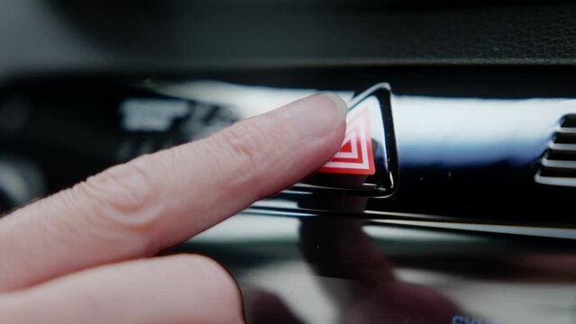 woman's hand presses the emergency button. presses the emergency stop button in the car.