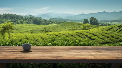 Foto op Aluminium Empty wooden table top board with tea coffee mug and tea plantation rays on the background. Organic green agriculture hills copy space banner © Alina Nikitaeva