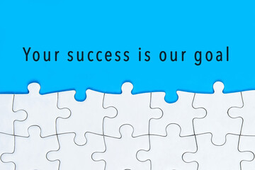 Your success is our goal text with Jigsaw Puzzle on Blue Background