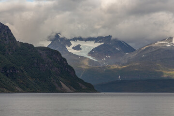 Glacier between mountains with lake at the base