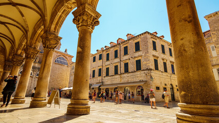 street view, crowds of tourists walking through the streets, medieval architecture, bright sunny...