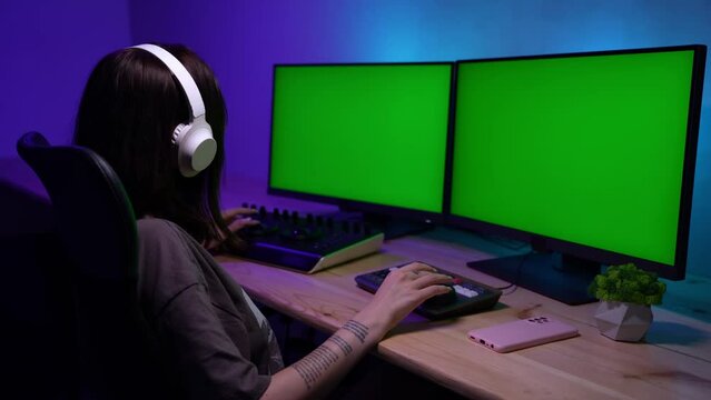 Portrait of female in white headphones listening music, editing video. Advertising area, workspace mockup.