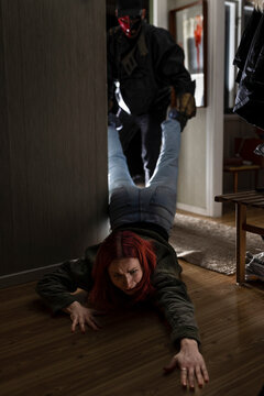Demon wearing mask pulling woman in cabin