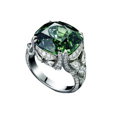 Green cushion sapphire in ring around diamond