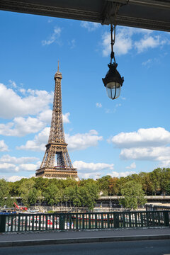 Eiffel tower in Paris during a sunny day .  Travel landmarks in Europe and France .