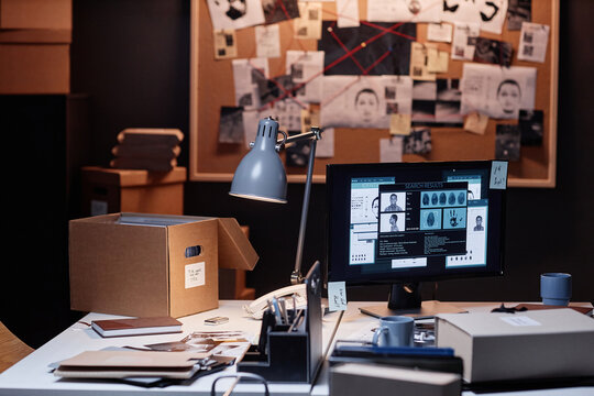 Image of detectives office with computer on desk and evidence board in background, copy space