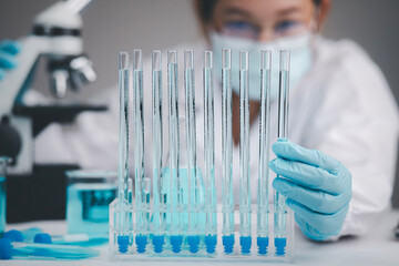 Medical Development Laboratory, biochemical research scientist Asian Doctor working with a microscope for vaccine development in the pharmaceutical research laboratory, Biotechnology Specialist