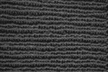 Handmade knitting material with macro weave threads.