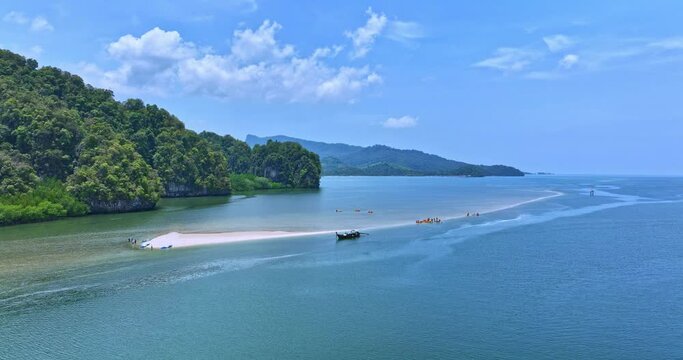 .Aerial view scenery white long sandbar stretch into the green sea. .tourists are relax on the white sandbar at Thalane Krabi Thailand. .Tourists Like to row a canoe in the mangrove forest.
