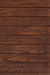 Fototapeta na wymiar dark brown wooden wall made of planks background