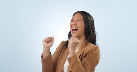 Excited, celebration and business woman with announcement, winner and yay from news in studio. Winning, promotion and success with wow from achievement of a female entrepreneur with blue background