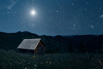 A Christmas star shines at night over the mountains of Bethlehem