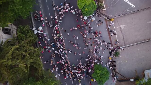 Top down aerial drone footage of people swing dancing in the streets. Noaptea Dansului - The night of the dances. Flash mob dancing swing dances.
