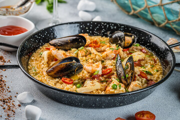 Italian Cuisine. Greek seafood and rice paella with shrimp, mussels and squid. on a light background