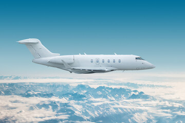White luxury private jet flies over snow covered mountain ranges