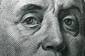 Benjamin Franklin's eyes on a hundred dollar bill. Benjamin Franklin portrait. United States national currency banknote fragment - obrazy, fototapety, plakaty