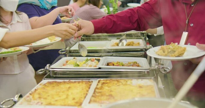 People hand take buffet food in hotel seminar room group of people party food
