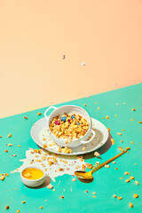 Bowl with sweet muesli, cereal with berries and milk against pastel background. Breakfast time. Concept of healthy food, nutrition, pop art style, taste. Poster. Copy space for ad