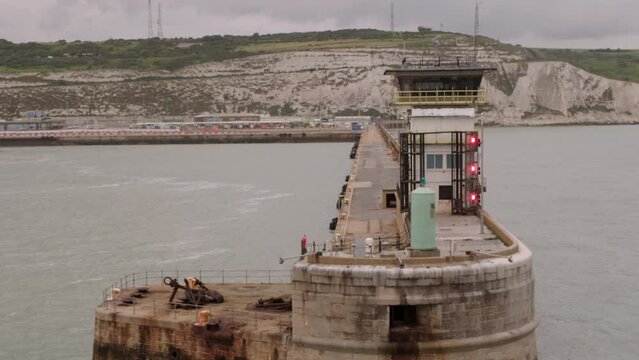 Dover port control tower shot from departing ferry with white cliffs in background