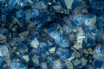 Blue Crystal Mineral Stone. Gems. Mineral crystals in the natural environment. Texture of precious and semiprecious stones. Seamless background with copy space colored shiny surface of precious stones