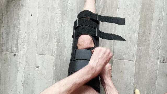 Closeup of knee brace to patient leg on background with copy space