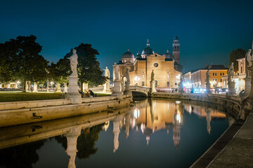 Padua, Italy - October 1, 2023: The Prato della Valle in the evening, is the largest square in the city of Padua. In the background the Church of Santa Giustina. - 656380718