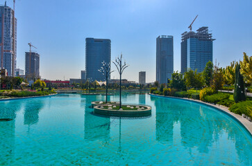 skyscrapers and lake with turquoise water in Tashkent City Park (Tashkent, Uzbekistan)