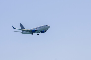 Fototapeta na wymiar Commercial airliner flying in blue sky 