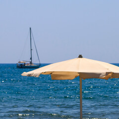 Canvas parasol on the beach in front of blue sea and sky, Cyprus