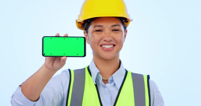Green screen phone, construction worker and a woman with mockup for contact or app information. Smile, face portrait and a female logistics employee with space on a mobile and studio background