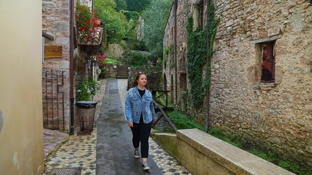 A Woman At The Enchanting Medieval Village Of  Streams Of Rasiglia In Perugia, Umbria Italy. Handheld