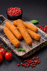 Delicious crispy cheese sticks with mozzarella, salt and spices, breaded and fried in oil