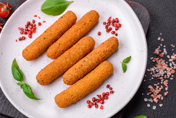 Delicious crispy cheese sticks with mozzarella, salt and spices, breaded and fried in oil