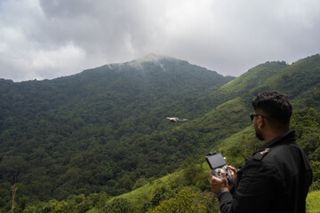 Standing on the hill and operating the drone, Shot on 02.12.2020, Kodagu, Karnataka, India