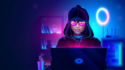 A teenage gamer in a hood is playing at a gaming laptop. A teenage girl or a boy in a hood is a hacker, a programmer writes code on a laptop in a dark room. A teenager is playing on a computer.
