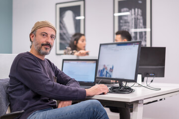 Proud man working in a modern co-working office