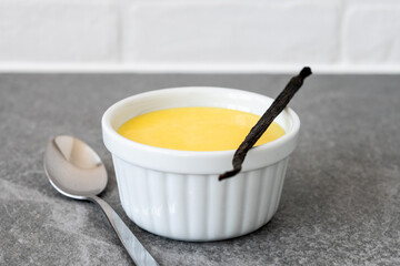 Homemade vanilla custard on gray stone background