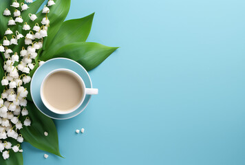 Lily of the Valley green leaves and Coffee Cup on Blue Background. Fresh Morning productivity with copy space, empty space