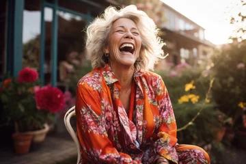 Fotobehang reife Frau lachend und sitzend im Freien, mature woman laughing and sitting outdoor © Gabi D